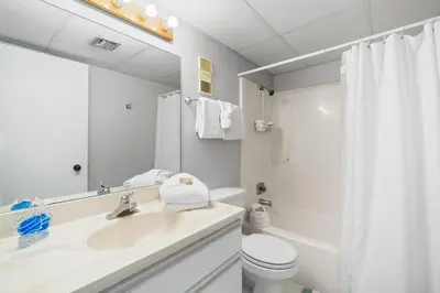 a white bathroom with a sink and a toilet at Pelican Walk 509 in Panama City Beach