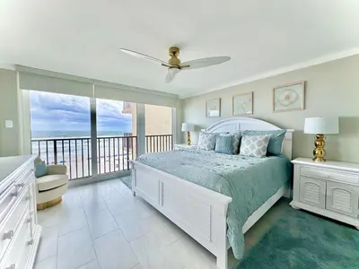 a bedroom with a bed and a balcony at Pelican Walk 405 in Panama City Beach