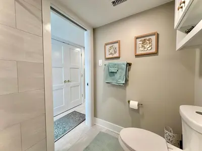 a bathroom with a toilet and a walk in shower at Pelican Walk 405 in Panama City Beach