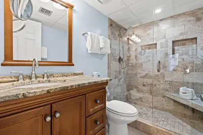 a bathroom with a toilet and a sink and a shower at Pelican Walk 710 in Panama City Beach