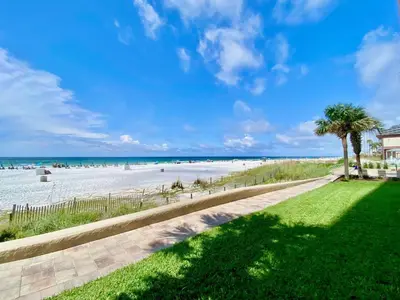 a view of a beach with palm trees at Pelican Walk 710 in Panama City Beach