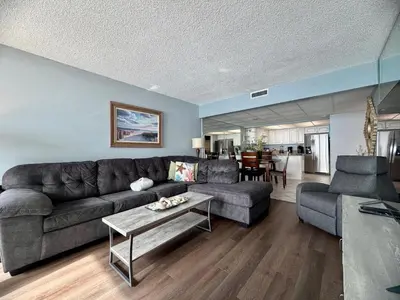 a living room with a couch and a table at Pelican Walk 710 in Panama City Beach