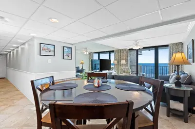a dining room with a table and chairs at Pelican Walk 610 in Panama City Beach