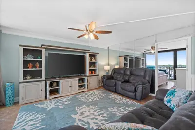 a living room with a couch and a television at Pelican Walk 812 in Panama City Beach