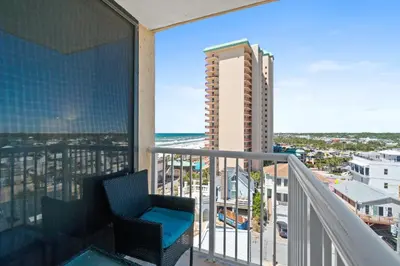a balcony with a chair and a view of the ocean at Pelican Walk 812 in Panama City Beach