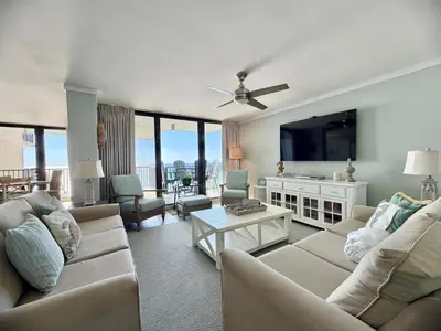 a living room with a couch and a tv at Pelican Walk 912 in Panama City Beach