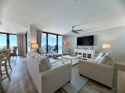 a living room with two couches and a tv at Pelican Walk 912 in Panama City Beach