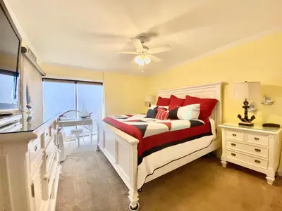 a bedroom with a bed and a ceiling fan at Gulfgate 304 in Panama City Beach