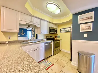 a kitchen with white cabinets and a sink at Gulfgate 304 in Panama City Beach