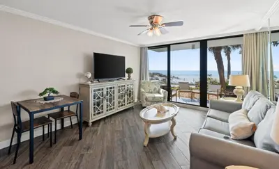 a living room with a couch and a tv at Pelican Walk 104 in Panama City Beach
