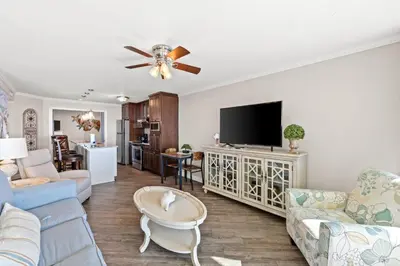 a living room with a couch and a tv at Pelican Walk 104 in Panama City Beach