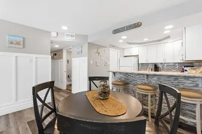 a kitchen and dining room with a table and chairs at Pelican Walk 703 in Panama City Beach