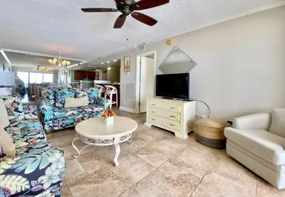 a living room with a couch and a tv at Gulfgate 311 in Panama City Beach