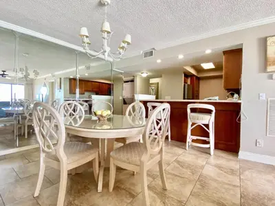 a dining room and kitchen with a table and chairs at Gulfgate 311 in Panama City Beach