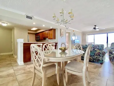 a dining room and kitchen with a table and chairs at Gulfgate 311 in Panama City Beach