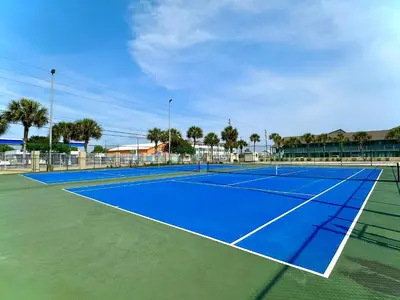 a tennis court with a blue tennis court at Pelican Walk 111 in Panama City Beach