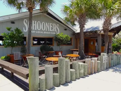 a restaurant with tables and chairs in front of a building at Pelican Walk 802 in Panama City Beach