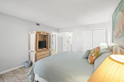 a bedroom with a bed and a television in it at Pelican Walk 706 in Panama City Beach