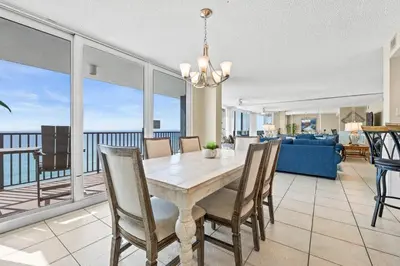a dining room with a table and views of the ocean at Pelican Walk 806 in Panama City Beach