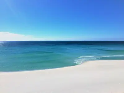 an empty beach with the ocean in the background at Pelican Walk 806 in Panama City Beach
