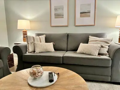 a living room with a couch and a coffee table at Cozy Beach Condo in Complex in Panama City Beach