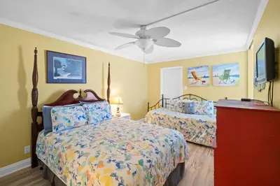 a bedroom with two beds and a ceiling fan at Pelican Walk 801 in Panama City Beach