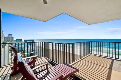 a balcony with two chairs and a view of the ocean at Pelican Walk 801 in Panama City Beach