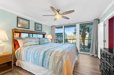 a bedroom with a bed and a ceiling fan at Pelican Walk 212 in Panama City Beach