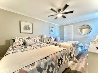 a bedroom with two beds and a ceiling fan at Pelican Walk 301 in Panama City Beach