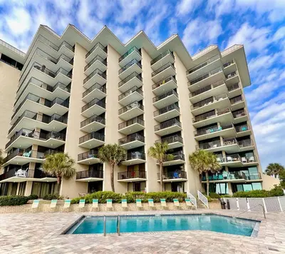 a large apartment building with a swimming pool at Pelican Walk 301 in Panama City Beach
