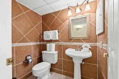 a bathroom with a toilet and a sink at Pelican Walk 103 in Panama City Beach