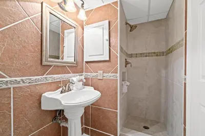 a bathroom with a sink and a mirror at Pelican Walk 103 in Panama City Beach