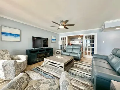 a living room with a couch and a tv at Pelican Walk 908 in Panama City Beach