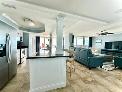 a kitchen and living room with a counter top at Pelican Walk 908 in Panama City Beach