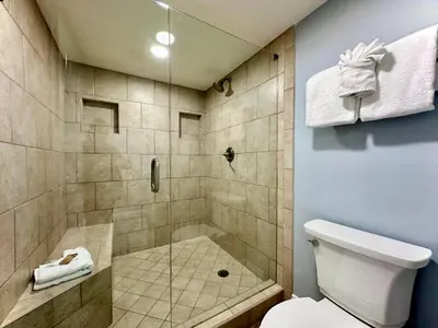 a bathroom with a shower and a toilet at Pelican Walk 908 in Panama City Beach