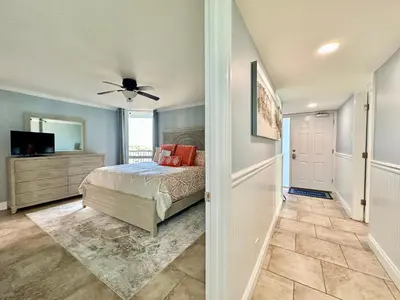 a bedroom with a bed and a ceiling fan at Pelican Walk 908 in Panama City Beach