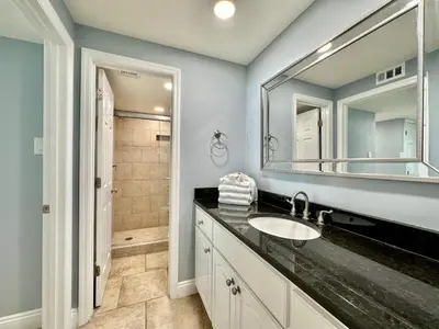 a bathroom with a sink and a mirror at Pelican Walk 908 in Panama City Beach