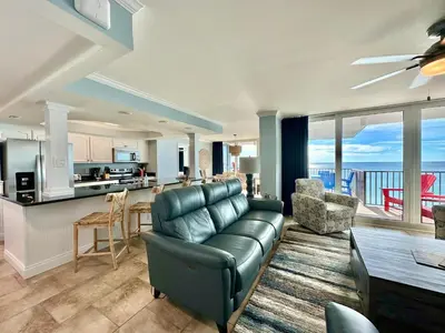 a living room with a couch and a kitchen at Pelican Walk 908 in Panama City Beach
