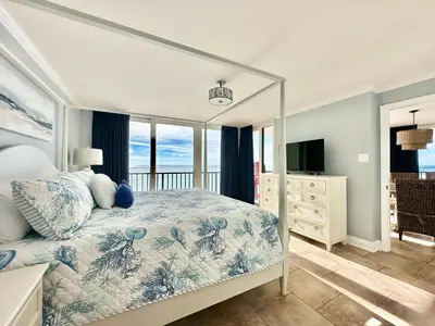 a bedroom with a bed with a view of the ocean at Pelican Walk 908 in Panama City Beach