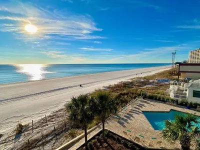 a view of a beach with palm trees and the ocean at Pelican Walk 406 in Panama City Beach