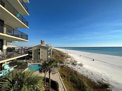 a view of the beach from the balcony of a resort at Pelican Walk 406 in Panama City Beach