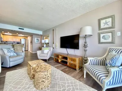 a living room with a flat screen tv and furniture at Pelican Walk 911 in Panama City Beach