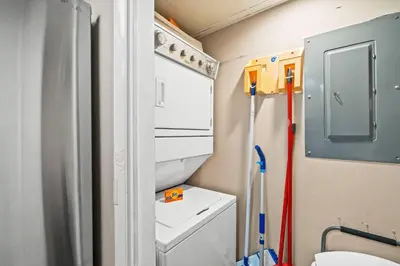 a small bathroom with a toilet and a washing machine at Pelican Walk 911 in Panama City Beach