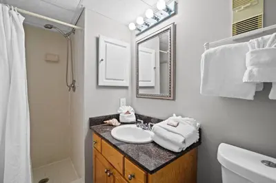 a bathroom with a sink and a mirror at Pelican Walk 911 in Panama City Beach