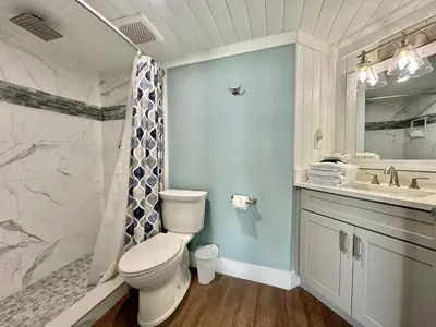 a bathroom with a toilet and a shower and a sink at Gulfgate 102 in Panama City Beach
