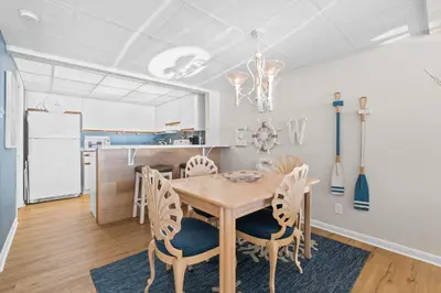 a kitchen and dining room with a table and chairs at Pelican Walk 704 in Panama City Beach