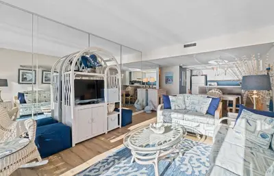a living room with a couch and a tv at Pelican Walk 704 in Panama City Beach