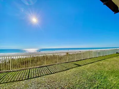 a fence on the beach with the ocean in the background at Gulfgate 103 in Panama City Beach