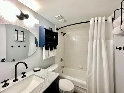 a bathroom with a tub and a sink and a toilet at Gulfgate 103 in Panama City Beach
