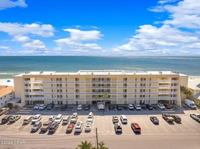 an aerial view of a hotel with cars parked in a parking lot at Gulfgate 103 in Panama City Beach